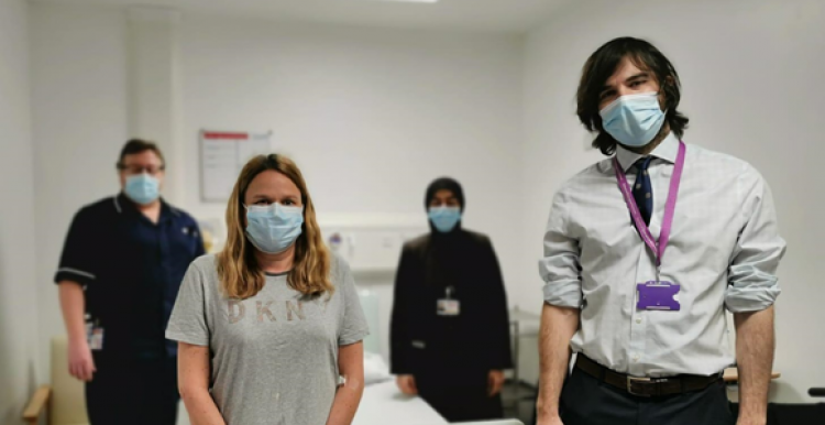 Four people wearing face masks inside the hospital